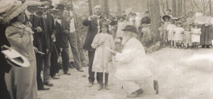 Angelo Mariani tout de blanc vêtu à genou devant la marraine. Derrière elle, le docteur Lutaud. A sa gauche Xavier Paoli et son chapeau melon.  Cliché issu du document intitulé : L'ile d'Or de Laurence Bureau-Lagane, juin 2013.
